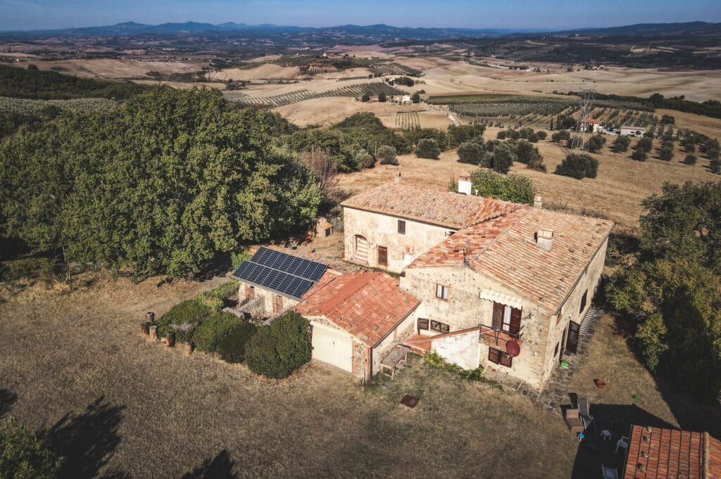 A large farmhouse with agricultural outbuildings